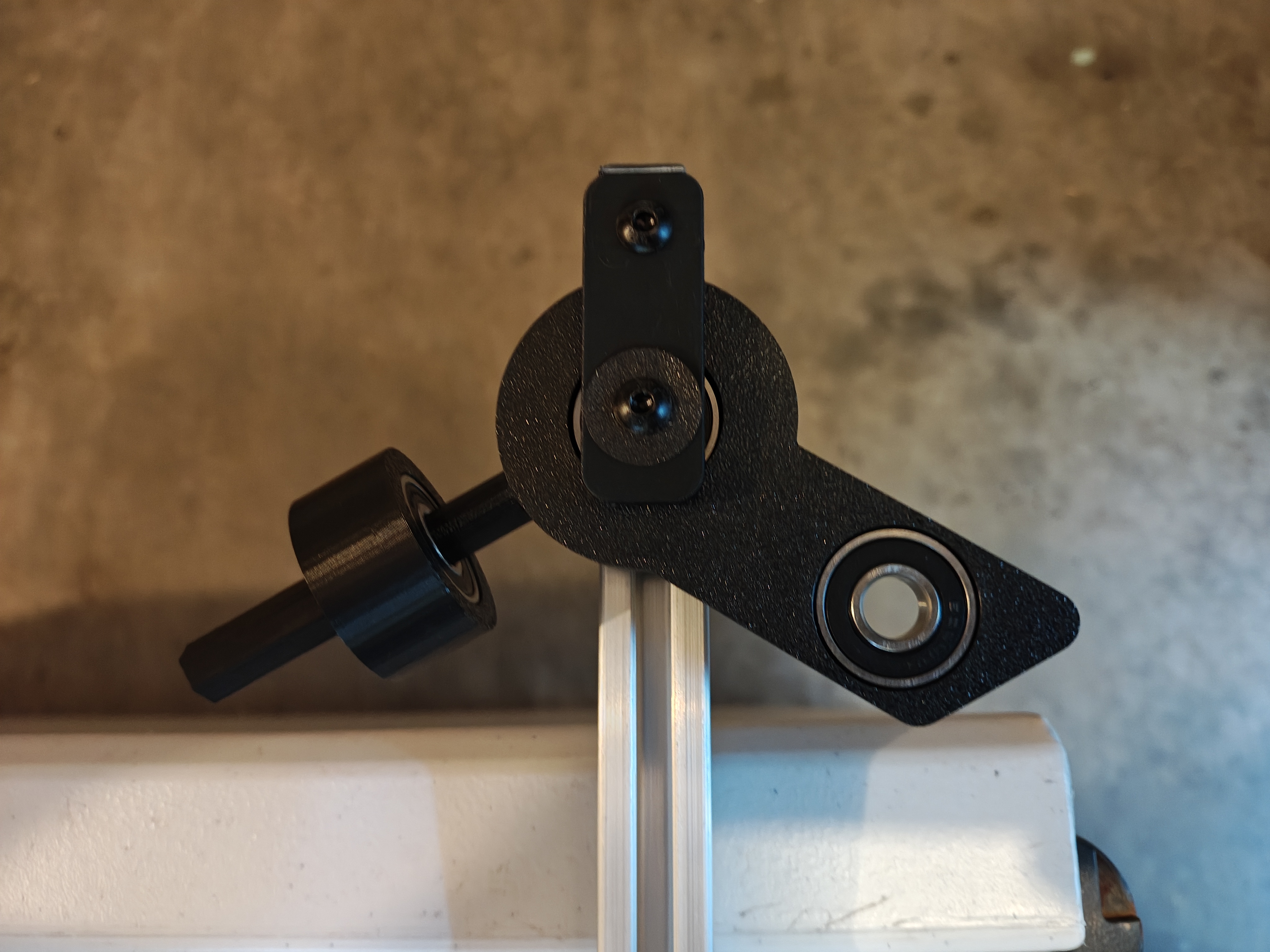 White 3D-printed steering knuckle attached to aluminum frame rail