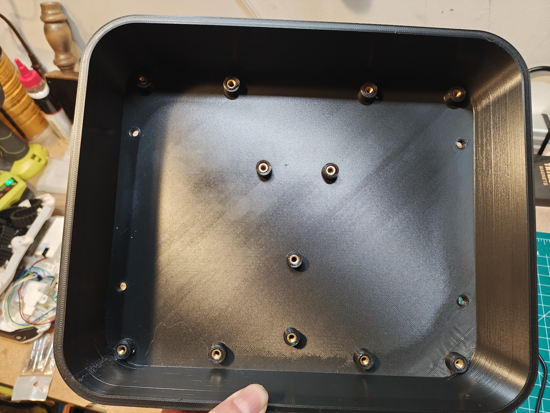 White 3D-printed enclosure with brass heat-set inserts visible in mounting holes