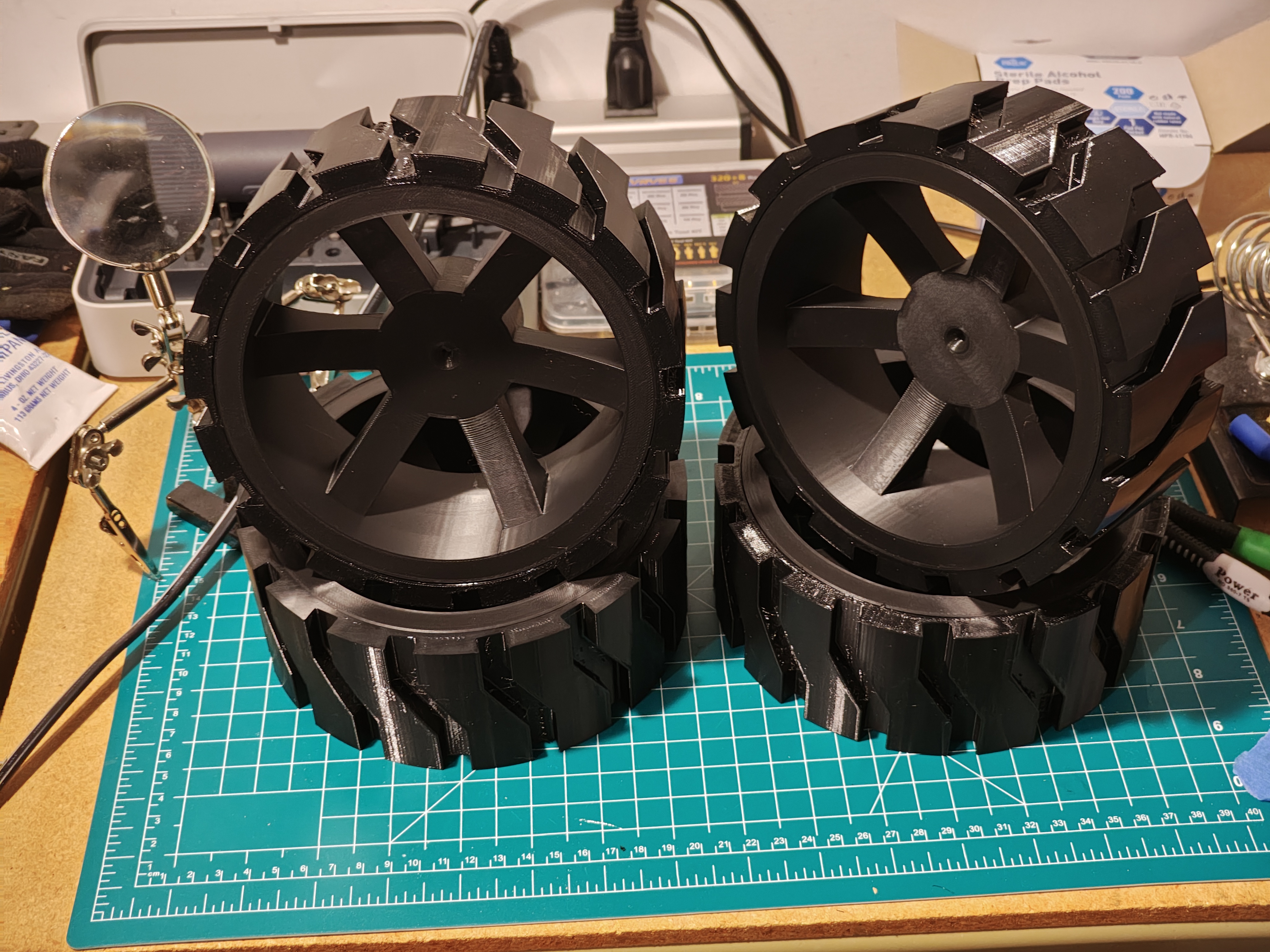 Two completed wheels with white hubs and black knobby tires side by side