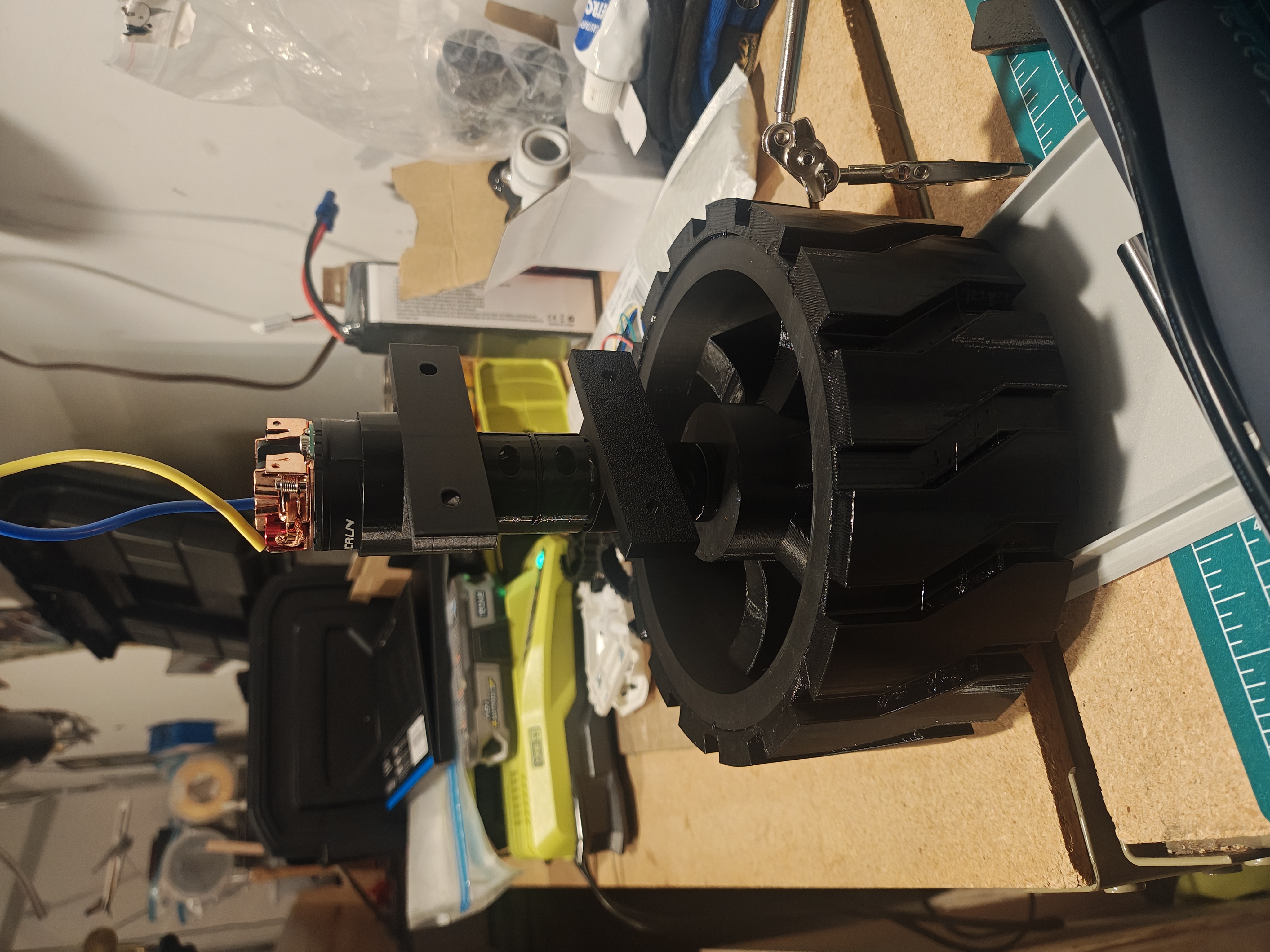 Complete assembly showing motor, coupler, bearing housing, and black wheel with tire attached