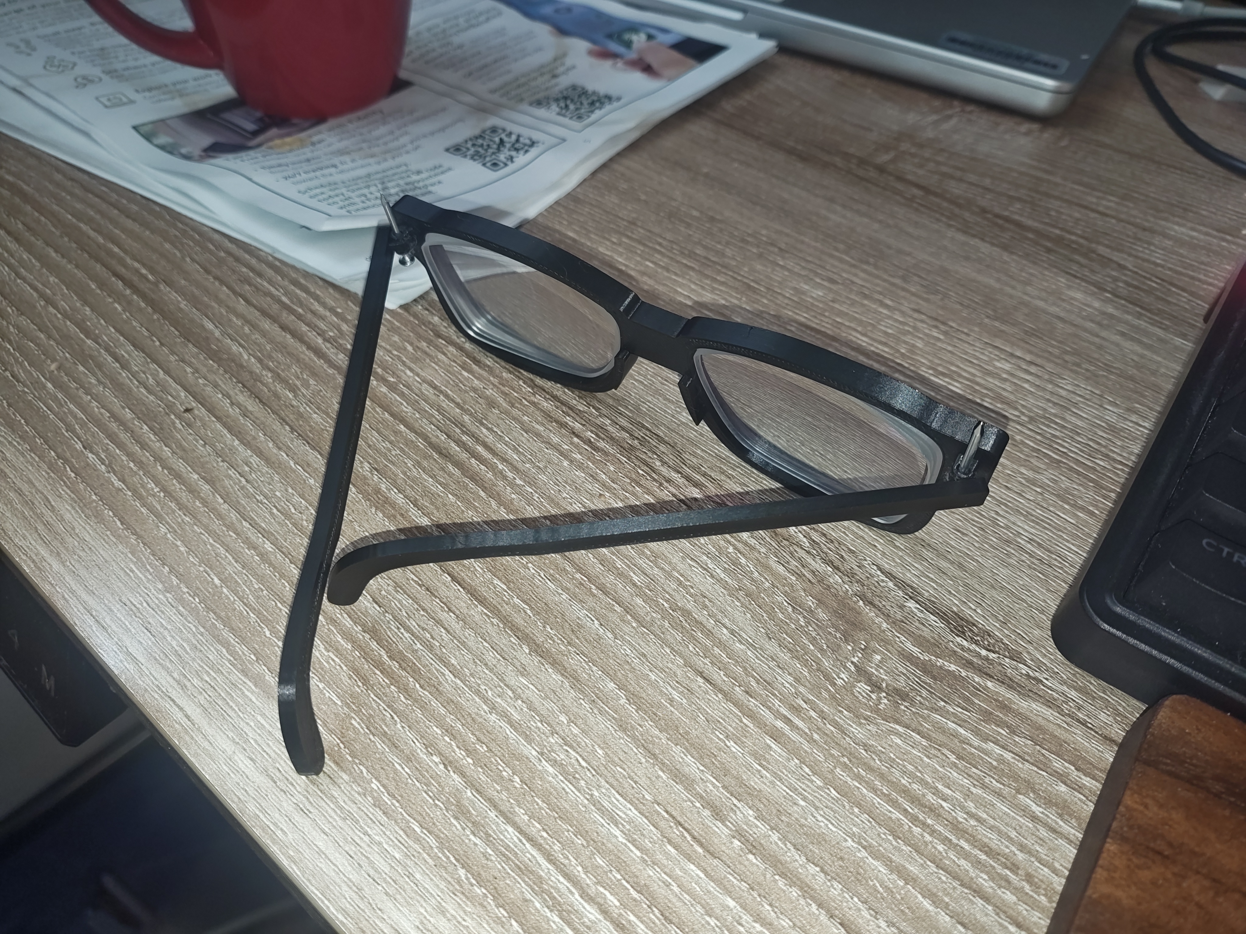 Final black glasses frames on desk