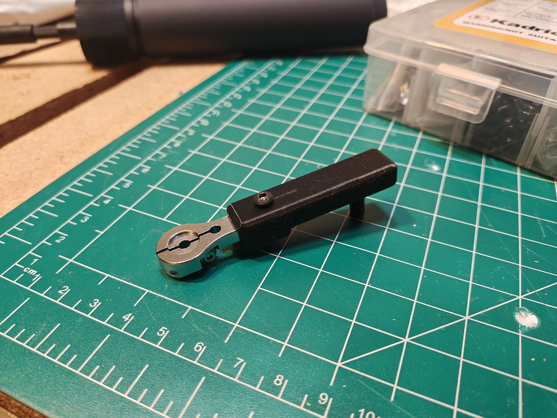 Small white 3D-printed cylindrical sleeve that fits over servo splines